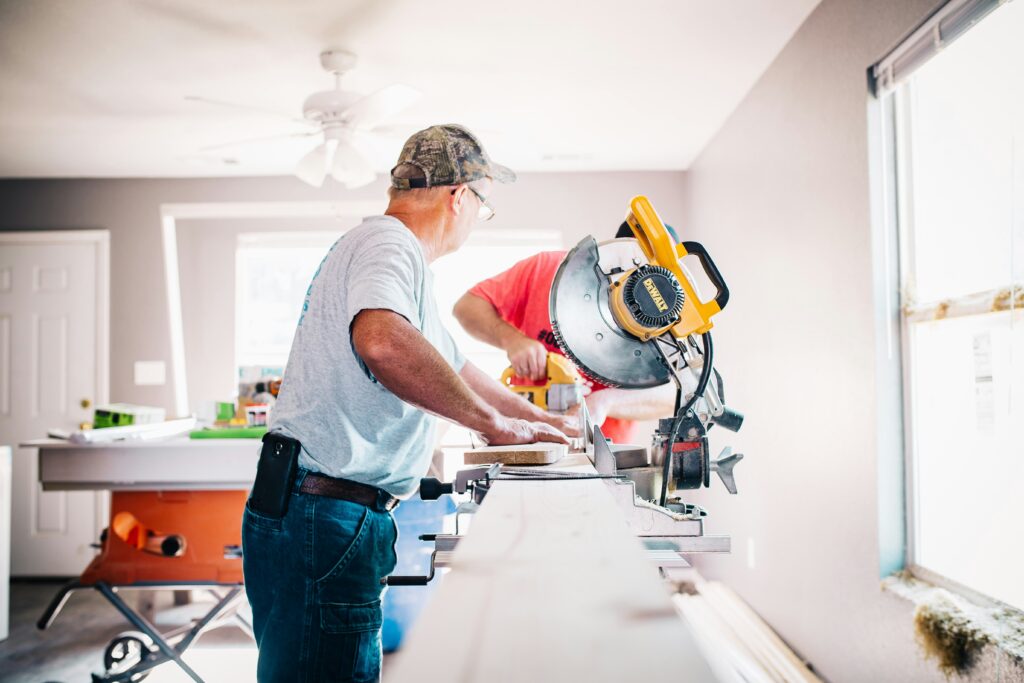 Man working with saw within a building under construction